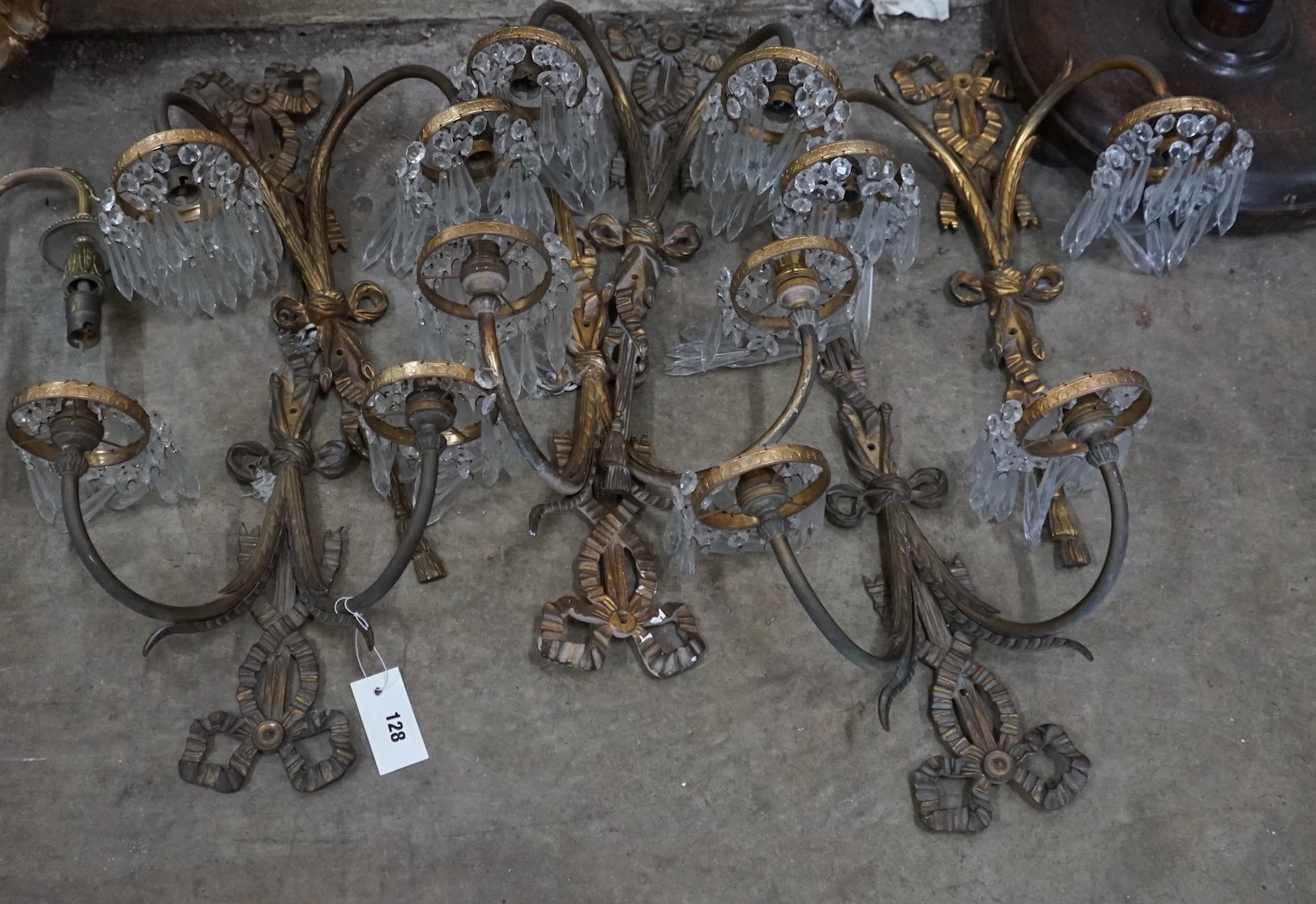 A set of eight gilt metal twin branch lustre wall lights, height 50cm